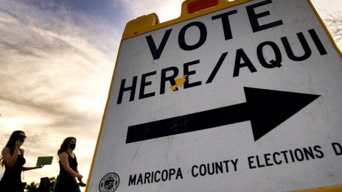 blake-Voters-deliver-their-ballot-to-a-polling-station-Tuesday-Nov.-3-2020-in-Tempe-Ariz.-AP-PhotoMatt-York.jpeg
